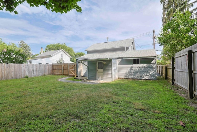 58 Wawayanda Ave, Middletown, NY 10940 - rear view of house with a fenced backyard and a shingled roof