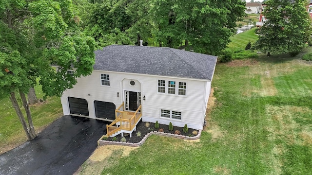 30 Wilson St, Middletown, NY 10940 - raised ranch with a shingled roof, asphalt driveway, a garage, and a front yard