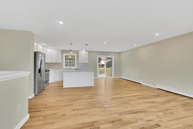 30 Wilson St, Middletown, NY 10940 - unfurnished living room with light wood-style floors, recessed lighting, and a baseboard radiator