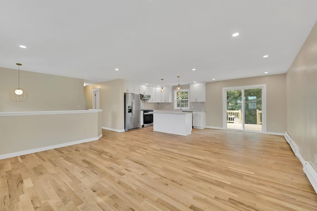 30 Wilson St, Middletown, NY 10940 - unfurnished living room featuring light wood finished floors, recessed lighting, and a baseboard heating unit