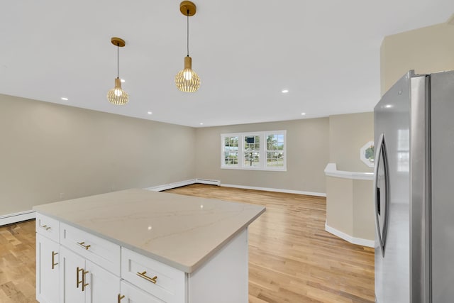 30 Wilson St, Middletown, NY 10940 - kitchen with freestanding refrigerator, light wood finished floors, decorative light fixtures, white cabinets, and recessed lighting