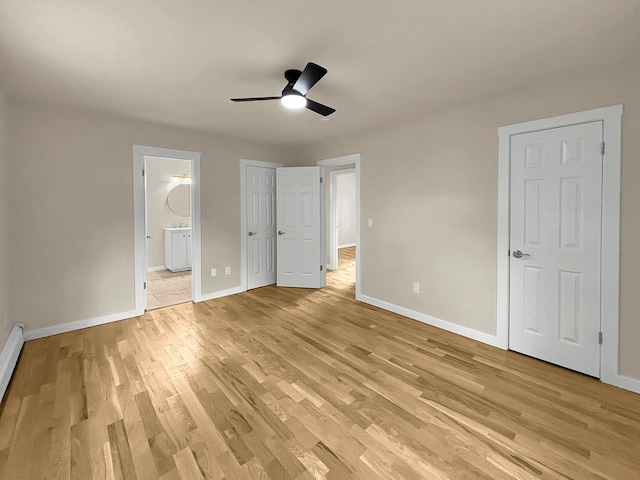 30 Wilson St, Middletown, NY 10940 - unfurnished bedroom with light wood finished floors, connected bathroom, a ceiling fan, and a baseboard radiator