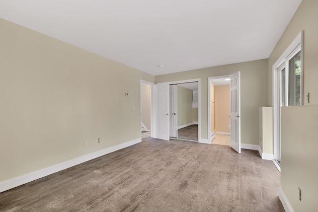 30 Wilson St, Middletown, NY 10940 - unfurnished bedroom with wood finished floors, connected bathroom, and a closet