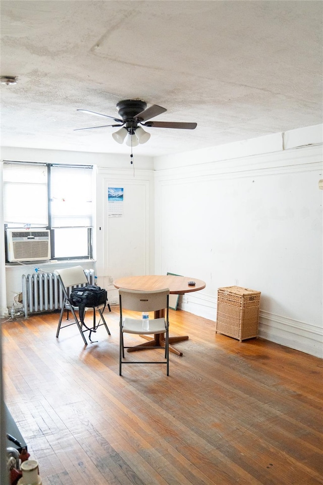 42-02 Layton St Unit 609, Elmhurst, NY 11373 - dining area featuring ceiling fan, radiator heating unit, and hardwood / wood-style flooring