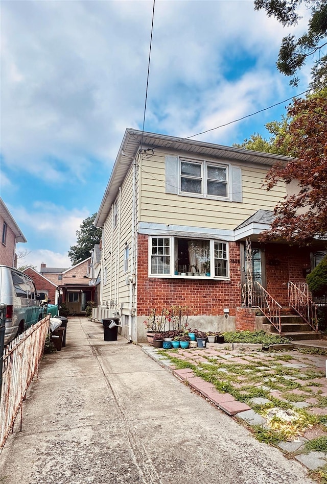 7506 164th St, Fresh Meadows, NY 11366 - traditional-style home featuring brick siding and concrete driveway