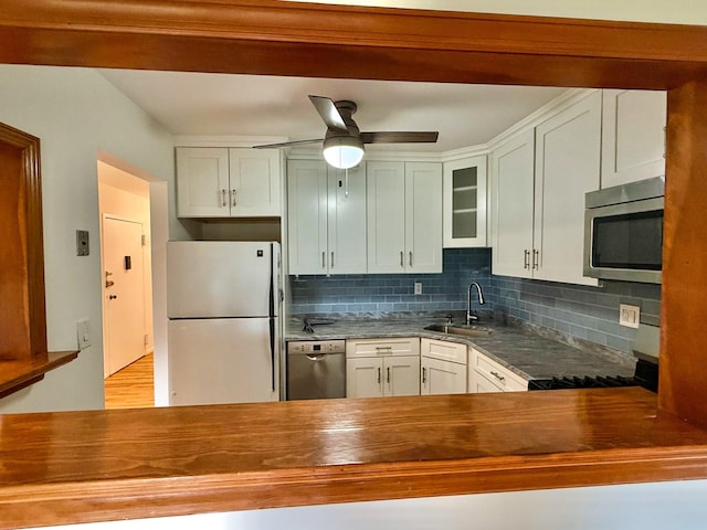 15 Blue Hill Commons, Orangeburg, NY 10962 - kitchen featuring appliances with stainless steel finishes, decorative backsplash, a ceiling fan, butcher block countertops, and glass insert cabinets