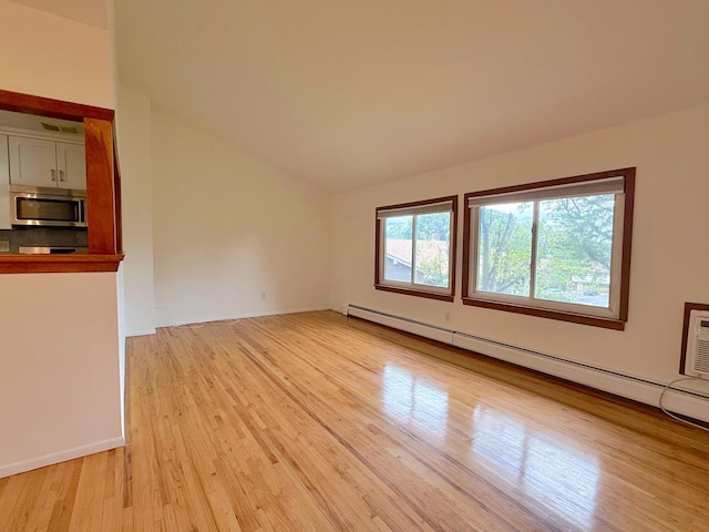 15 Blue Hill Commons, Orangeburg, NY 10962 - unfurnished room featuring a baseboard heating unit, lofted ceiling, and light wood-style flooring