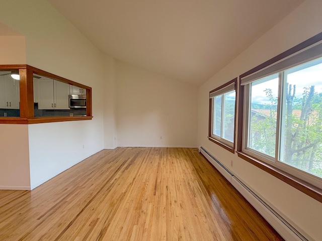 15 Blue Hill Commons, Orangeburg, NY 10962 - empty room with baseboard heating, vaulted ceiling, and light wood-style floors