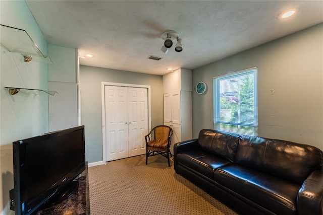 100 Baker Ct Unit 128, Island Park, NY 11558 - living area featuring light colored carpet and recessed lighting