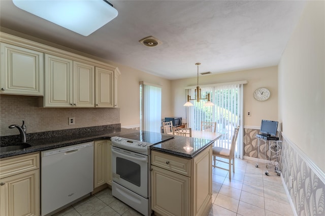 100 Baker Ct Unit 128, Island Park, NY 11558 - kitchen featuring cream cabinetry, white appliances, a peninsula, wainscoting, and light tile patterned floors