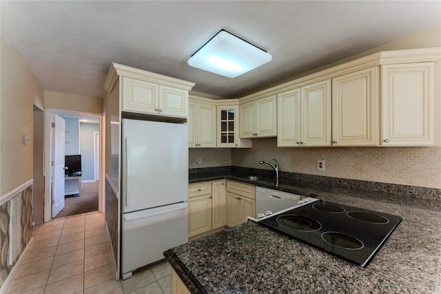 100 Baker Ct Unit 128, Island Park, NY 11558 - kitchen with white appliances, cream cabinetry, light tile patterned flooring, tasteful backsplash, and glass insert cabinets