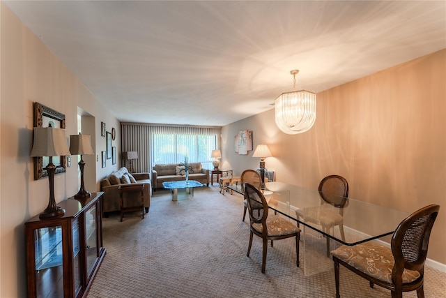 100 Baker Ct Unit 128, Island Park, NY 11558 - dining area featuring carpet floors and a chandelier