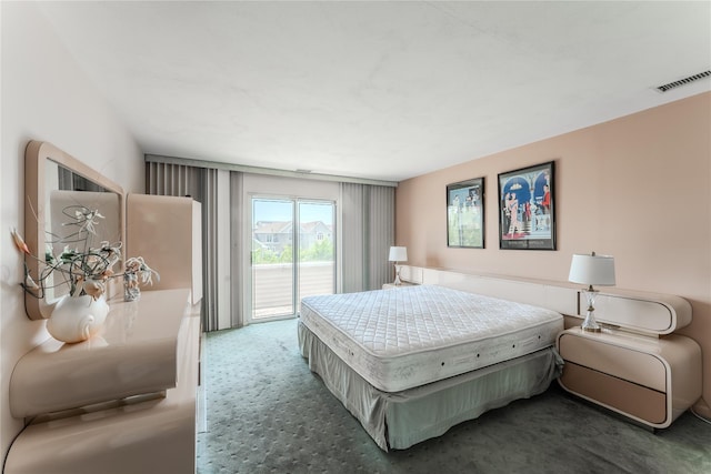 100 Baker Ct Unit 128, Island Park, NY 11558 - bedroom with access to exterior and carpet