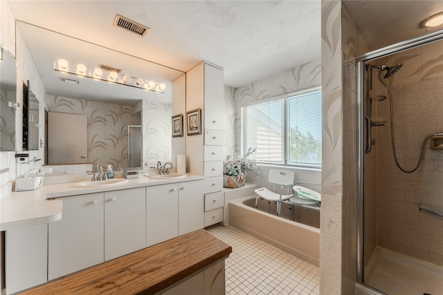100 Baker Ct Unit 128, Island Park, NY 11558 - full bath featuring a shower stall, double vanity, a bath, and tile patterned floors