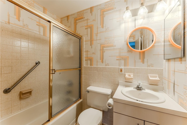 100 Baker Ct Unit 128, Island Park, NY 11558 - bathroom with vanity, combined bath / shower with glass door, and tile walls