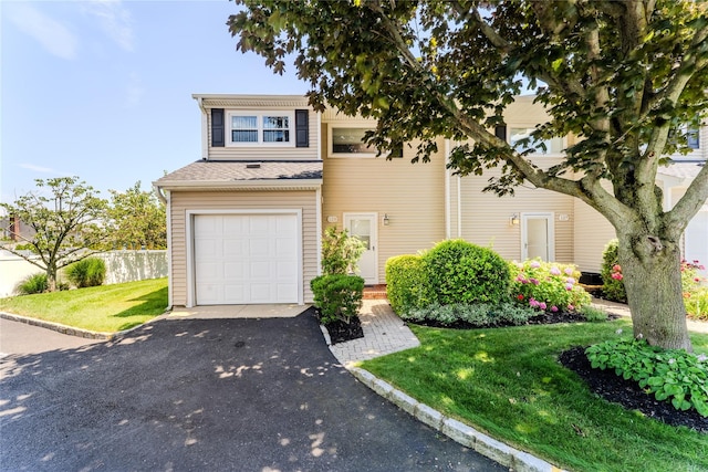 100 Baker Ct Unit 128, Island Park, NY 11558 - view of front of house with driveway and an attached garage