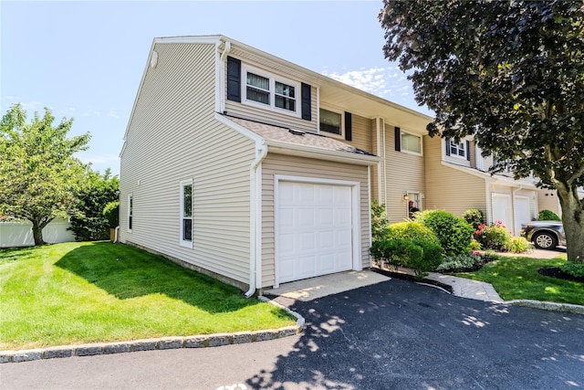 100 Baker Ct Unit 128, Island Park, NY 11558 - traditional-style home featuring driveway, a front yard, an attached garage, and a shingled roof