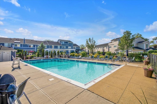 100 Baker Ct Unit 128, Island Park, NY 11558 - community pool featuring a residential view and a patio area