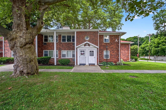 2710 S Rd Unit A4, Poughkeepsie, NY 12601 - view of front facade with a front lawn, brick siding, and a chimney