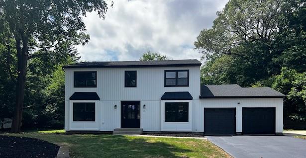 21 Kent Pl, Smithtown, NY 11787 - modern inspired farmhouse with an attached garage, driveway, and a front lawn