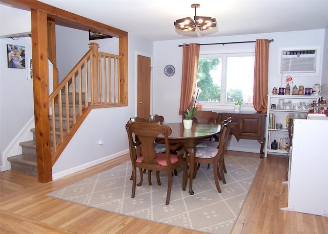 73 Peconic St, Selden, NY 11784 - dining area featuring a chandelier, wood finished floors, stairway, and a wall unit AC