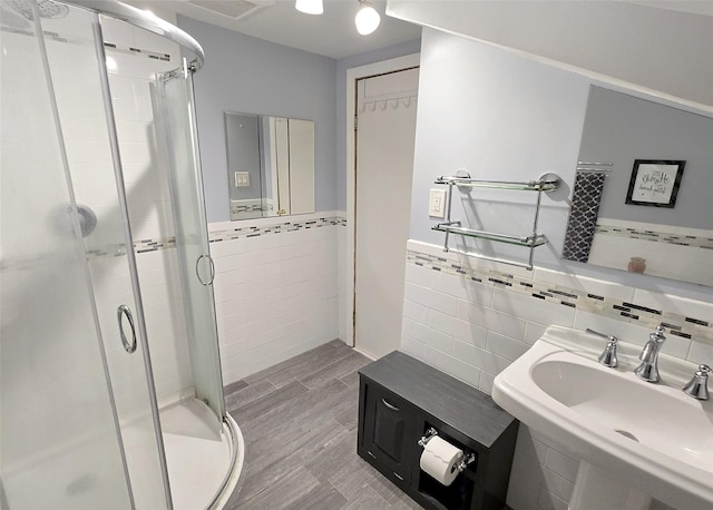 73 Peconic St, Selden, NY 11784 - full bathroom with tile walls, a shower stall, wood finished floors, and wainscoting