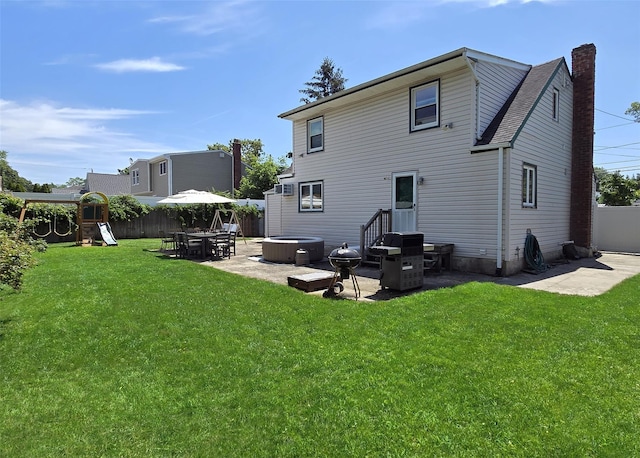 73 Peconic St, Selden, NY 11784 - rear view of house with a patio, a chimney, a fenced backyard, and a playground