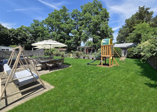 73 Peconic St, Selden, NY 11784 - fenced backyard featuring a playground and a patio