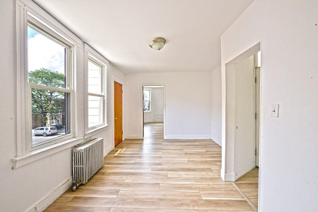 5822 Penrod St, Corona, NY 11368 - hallway featuring radiator heating unit and light wood-style floors