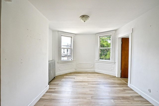 5822 Penrod St, Corona, NY 11368 - unfurnished room featuring radiator and light wood-style flooring