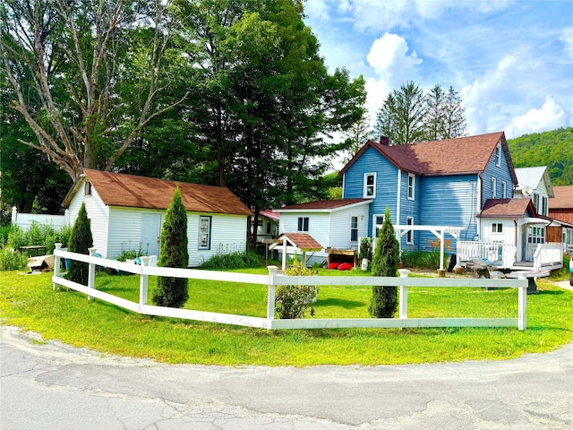 61 Cottage St, Roscoe, NY 12776 - view of front of property featuring a fenced front yard and an outbuilding
