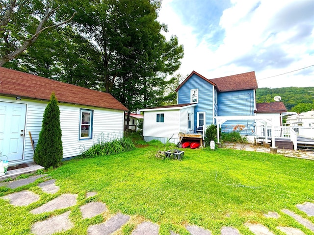 61 Cottage St, Roscoe, NY 12776 - rear view of house featuring a lawn, a deck, and roof with shingles