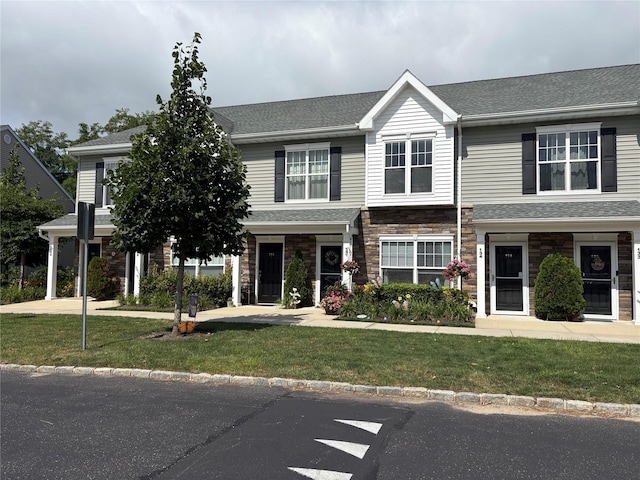 132 Weatherby Ln Unit 132, Central Islip, NY 11722 - view of front of house featuring a front lawn, stone siding, and a shingled roof