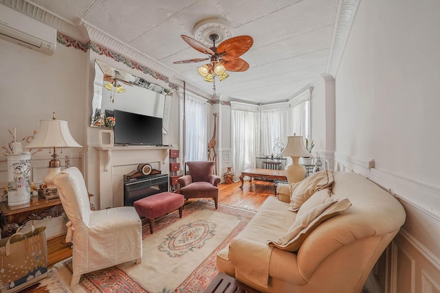 65 Granite St, Brooklyn, NY 11207 - living room featuring a wall mounted AC, ornamental molding, a fireplace, wood finished floors, and ceiling fan