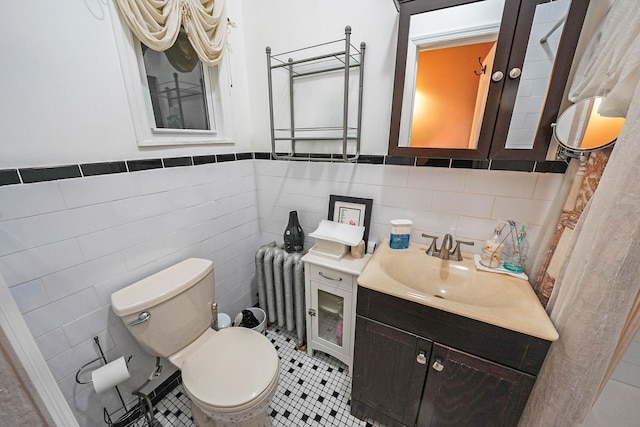 65 Granite St, Brooklyn, NY 11207 - bathroom featuring tile walls, vanity, a wainscoted wall, radiator, and tile patterned flooring
