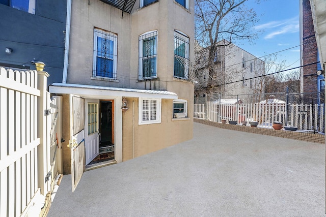 65 Granite St, Brooklyn, NY 11207 - view of exterior entry with stucco siding and a patio