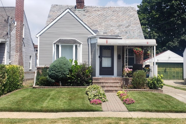 269 Windsor Pkwy, Hempstead, NY 11550 - view of front of home with a chimney, an outdoor structure, a front yard, and a high end roof