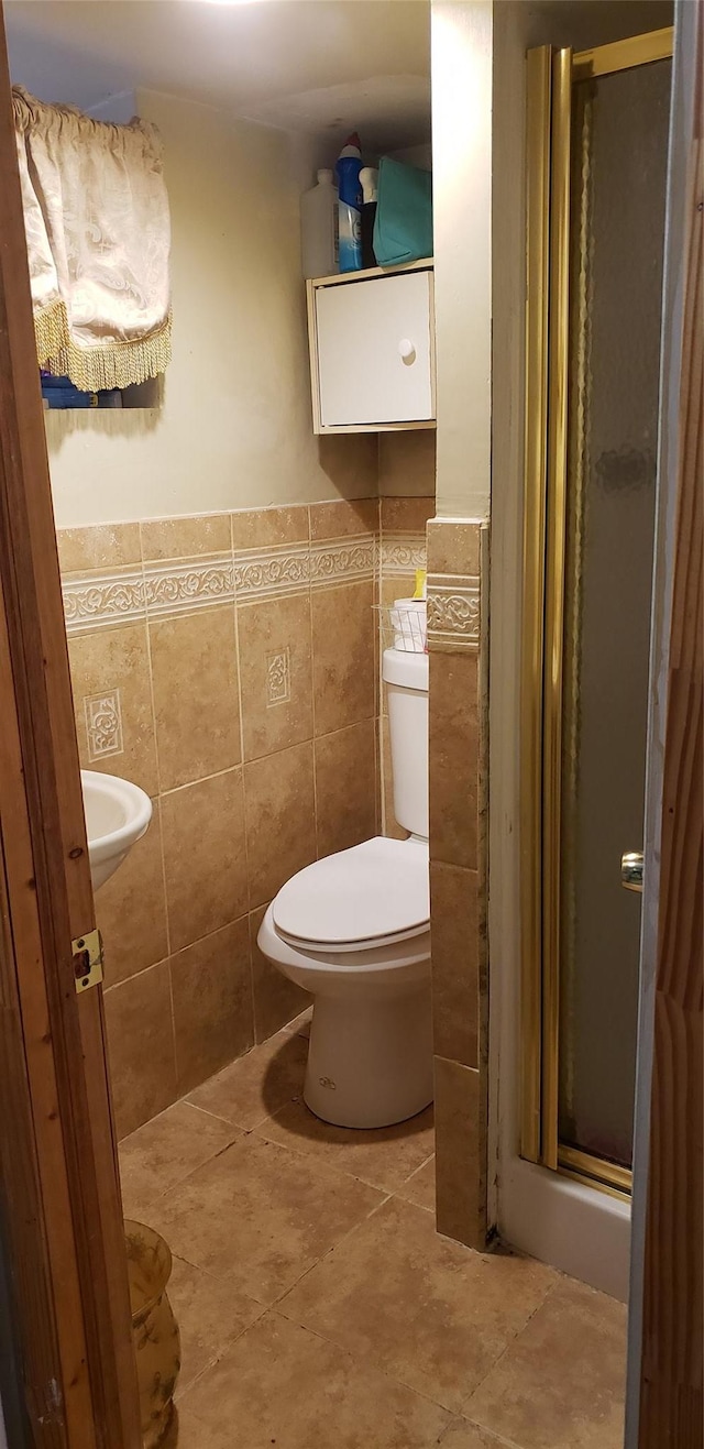 269 Windsor Pkwy, Hempstead, NY 11550 - bathroom with a stall shower, tile walls, and wainscoting