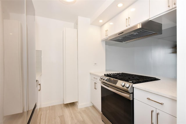 152-18 Union Tpke Unit 12T, Flushing, NY 11367 - kitchen featuring gas stove, under cabinet range hood, light wood-style floors, light countertops, and white cabinetry