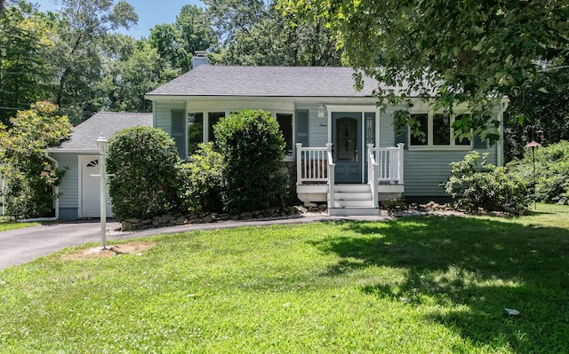 3 N Jackson Rd, Poughkeepsie, NY 12603 - view of front of property featuring a chimney, a front lawn, asphalt driveway, a shingled roof, and covered porch