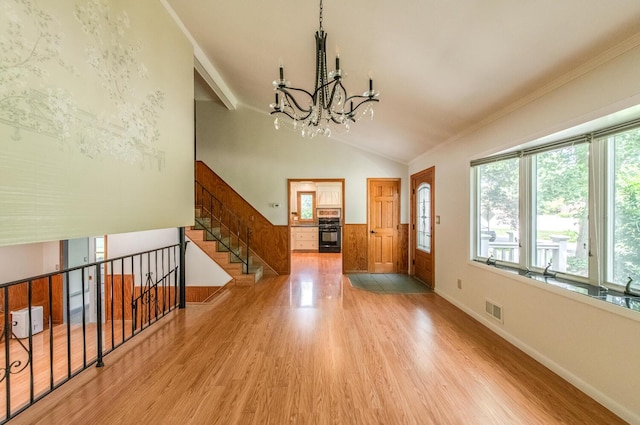 3 N Jackson Rd, Poughkeepsie, NY 12603 - foyer entrance with wood finished floors, a chandelier, crown molding, lofted ceiling, and stairs