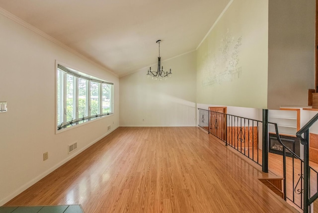 3 N Jackson Rd, Poughkeepsie, NY 12603 - unfurnished room with a chandelier, crown molding, wood finished floors, and vaulted ceiling