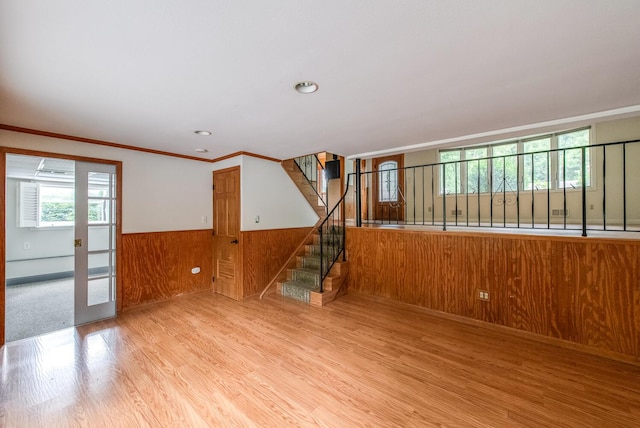 3 N Jackson Rd, Poughkeepsie, NY 12603 - unfurnished living room featuring wood finished floors, wainscoting, stairs, crown molding, and wooden walls