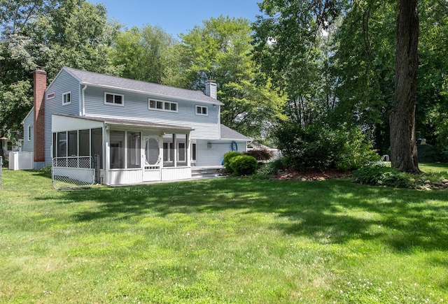 3 N Jackson Rd, Poughkeepsie, NY 12603 - back of property with a chimney, a sunroom, a yard, and roof with shingles