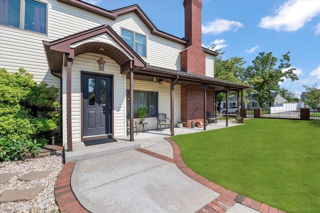 8 Pearl St, Bethpage, NY 11714 - view of exterior entry featuring a chimney and a patio