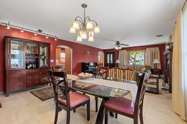 8 Pearl St, Bethpage, NY 11714 - dining area with arched walkways, rail lighting, a chandelier, ceiling fan, and light tile patterned floors