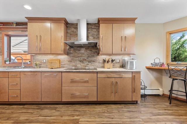 8 Pearl St, Bethpage, NY 11714 - kitchen with wall chimney range hood, black electric stovetop, backsplash, light wood-style floors, and a baseboard heating unit