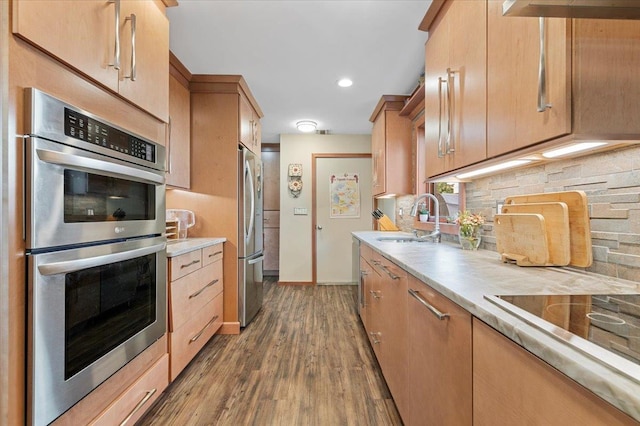 8 Pearl St, Bethpage, NY 11714 - kitchen with appliances with stainless steel finishes, light countertops, wood finished floors, backsplash, and range hood
