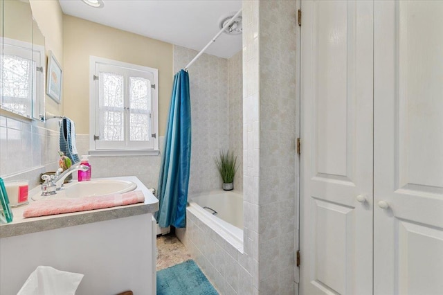8 Pearl St, Bethpage, NY 11714 - bathroom featuring vanity, tiled shower / bath combo, tile walls, and tile patterned flooring