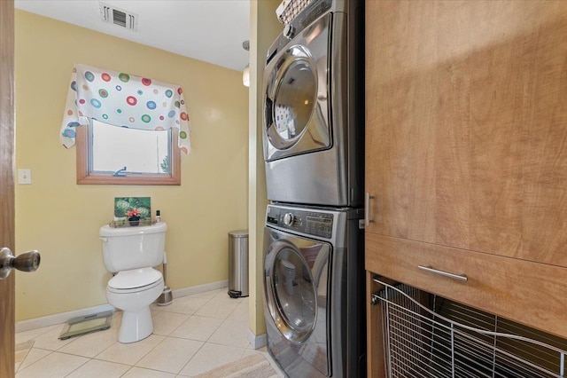8 Pearl St, Bethpage, NY 11714 - washroom featuring stacked washer / dryer and light tile patterned floors